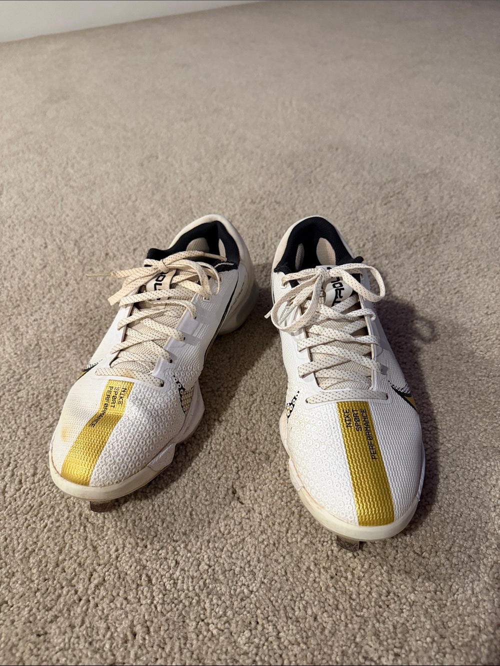 Nike White Athletic Cleats with Yellow Stripe